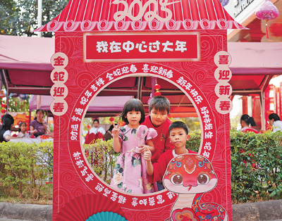 老撾民眾在“歡樂春節(jié)”廟會現(xiàn)場設立的新春祈福打卡點拍照。  坎帕頌攝